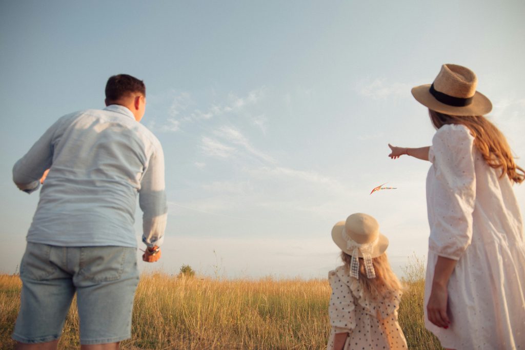 A family gazing up at the sky